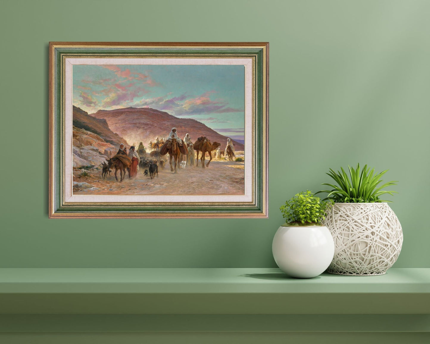 A Desert Caravan Painting by Eugine Girardet Wall Art Print framed hanging above wall shelf next to small planters