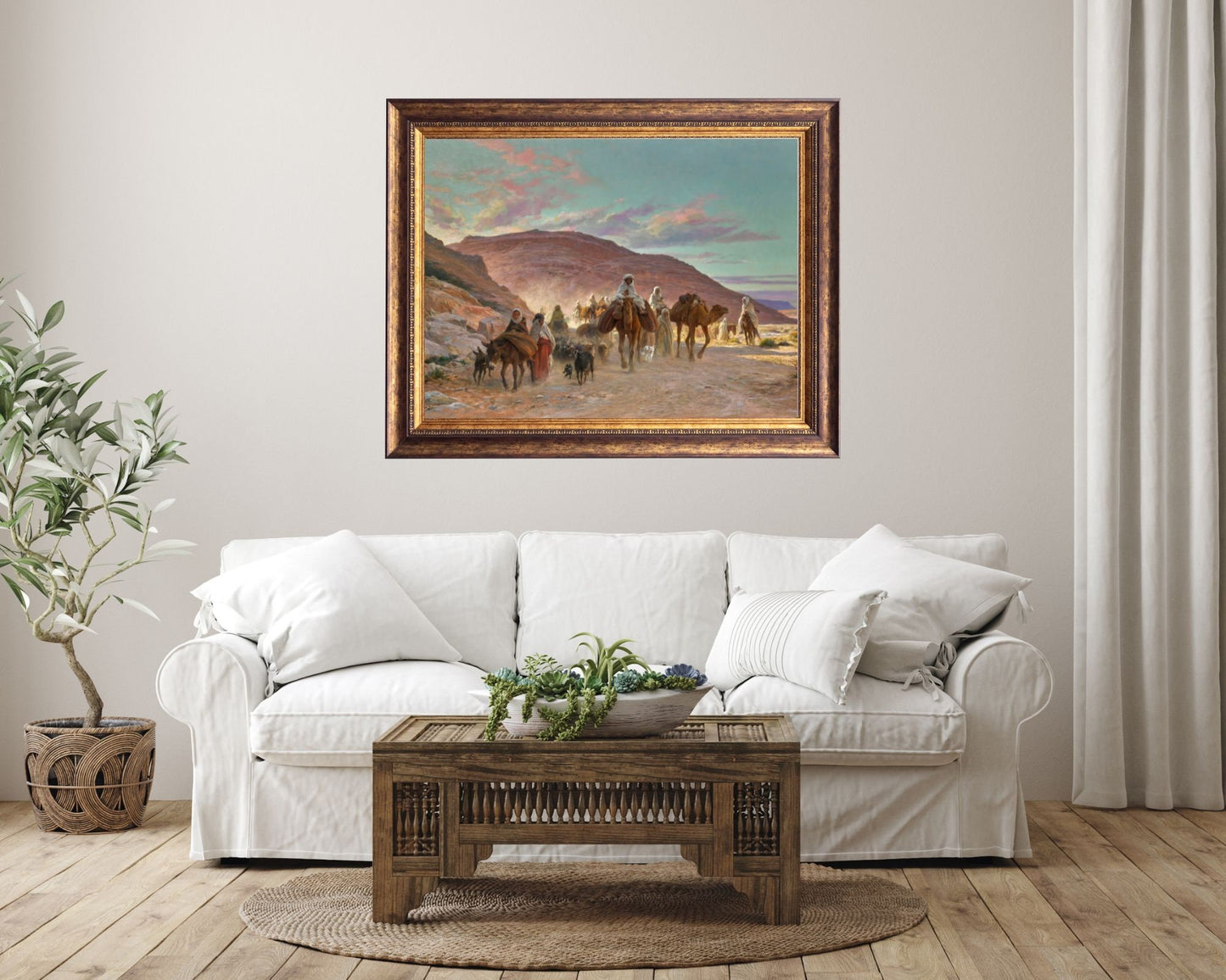 A Desert Caravan Painting by Eugine Girardet Art Print framed hanging on wall above white sofa