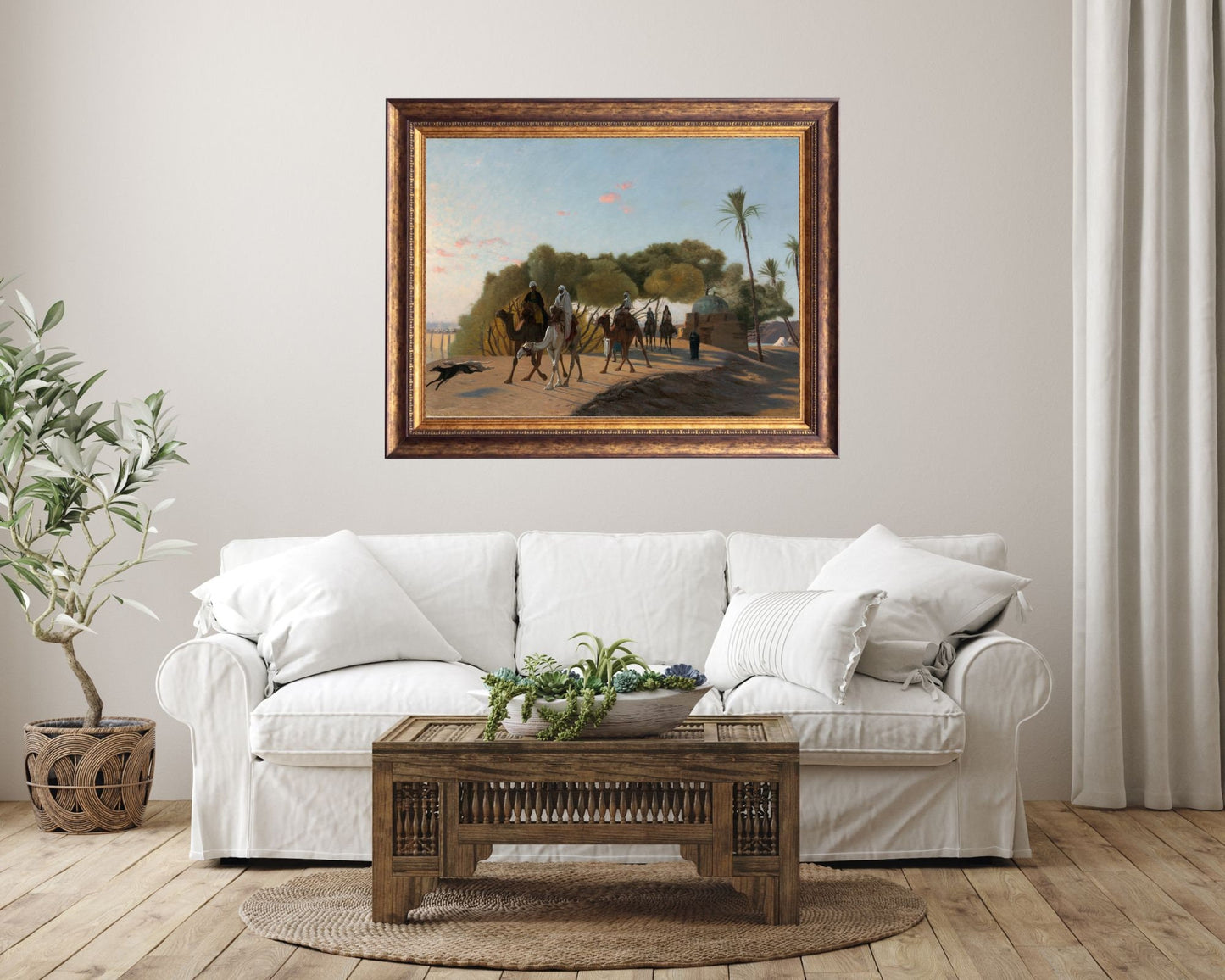 Leaving the Oasis Painting by Jean Leon Gerome Wall Art Print framed hanging on wall above white sofa