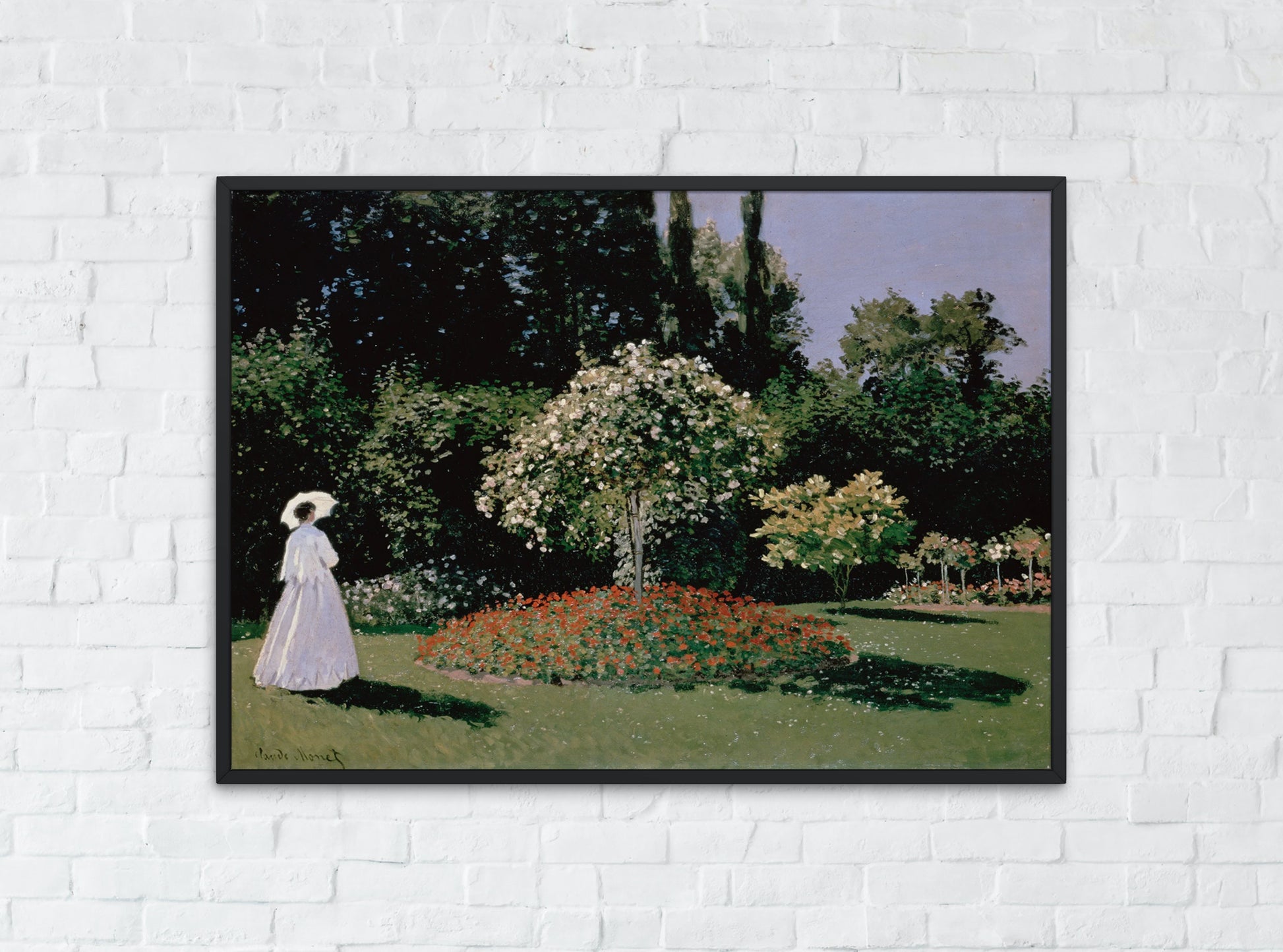 woman in the garden by Monet framed art print hanging on the wall