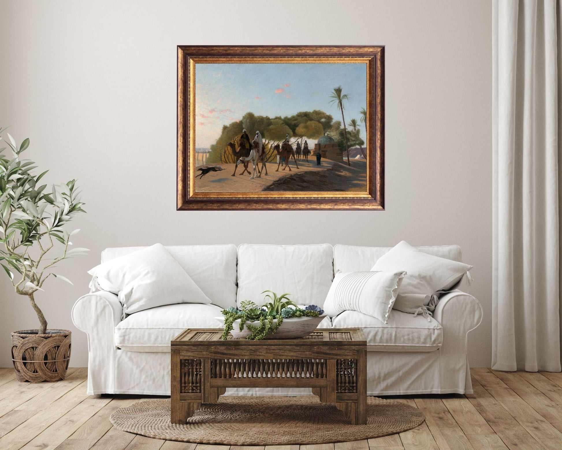Leaving the Oasis Painting by Jean Leon Gerome Wall Art Print framed hanging on wall above white sofa